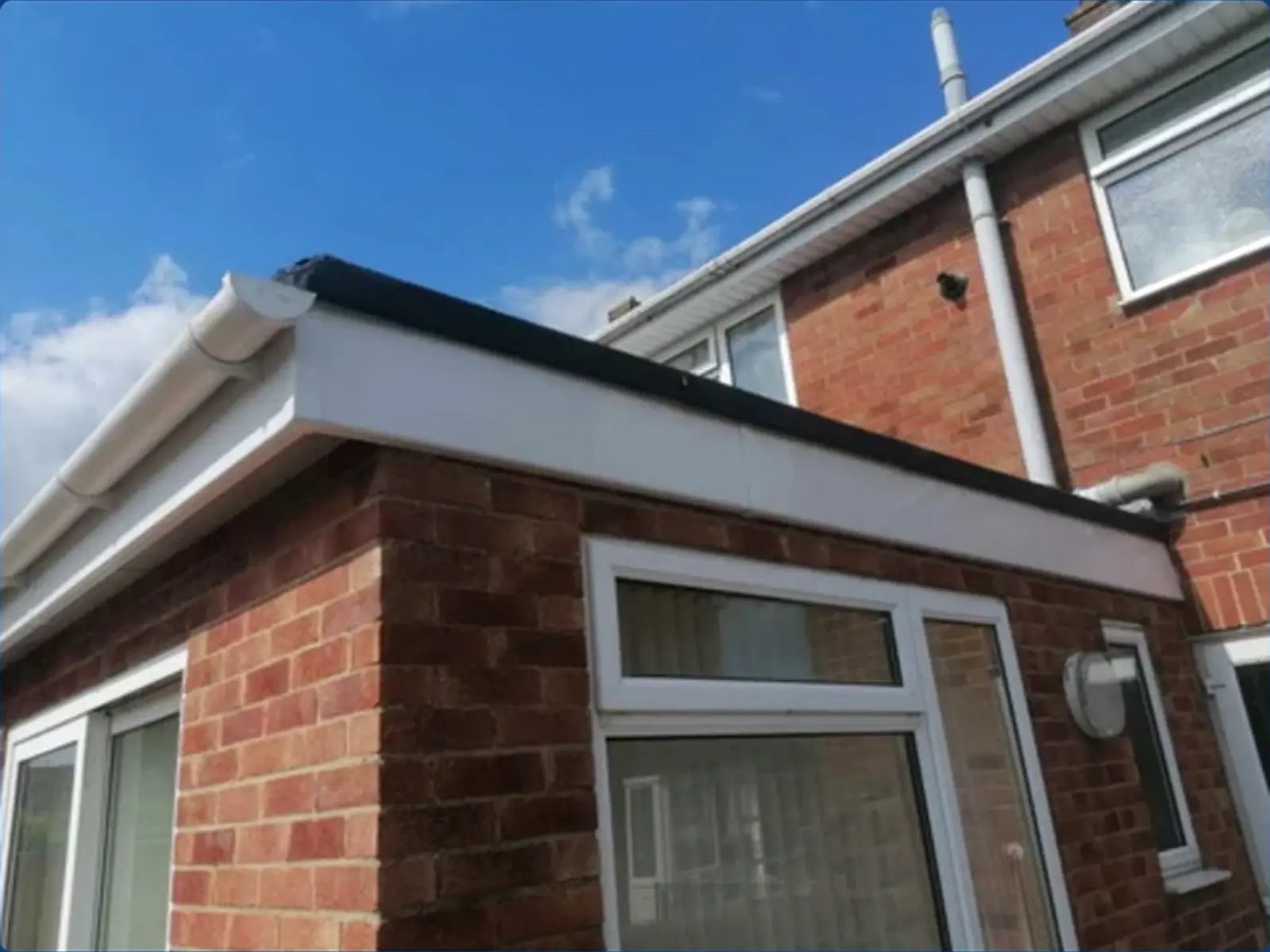 Finished roofline, fascia and gutter on a brick extension