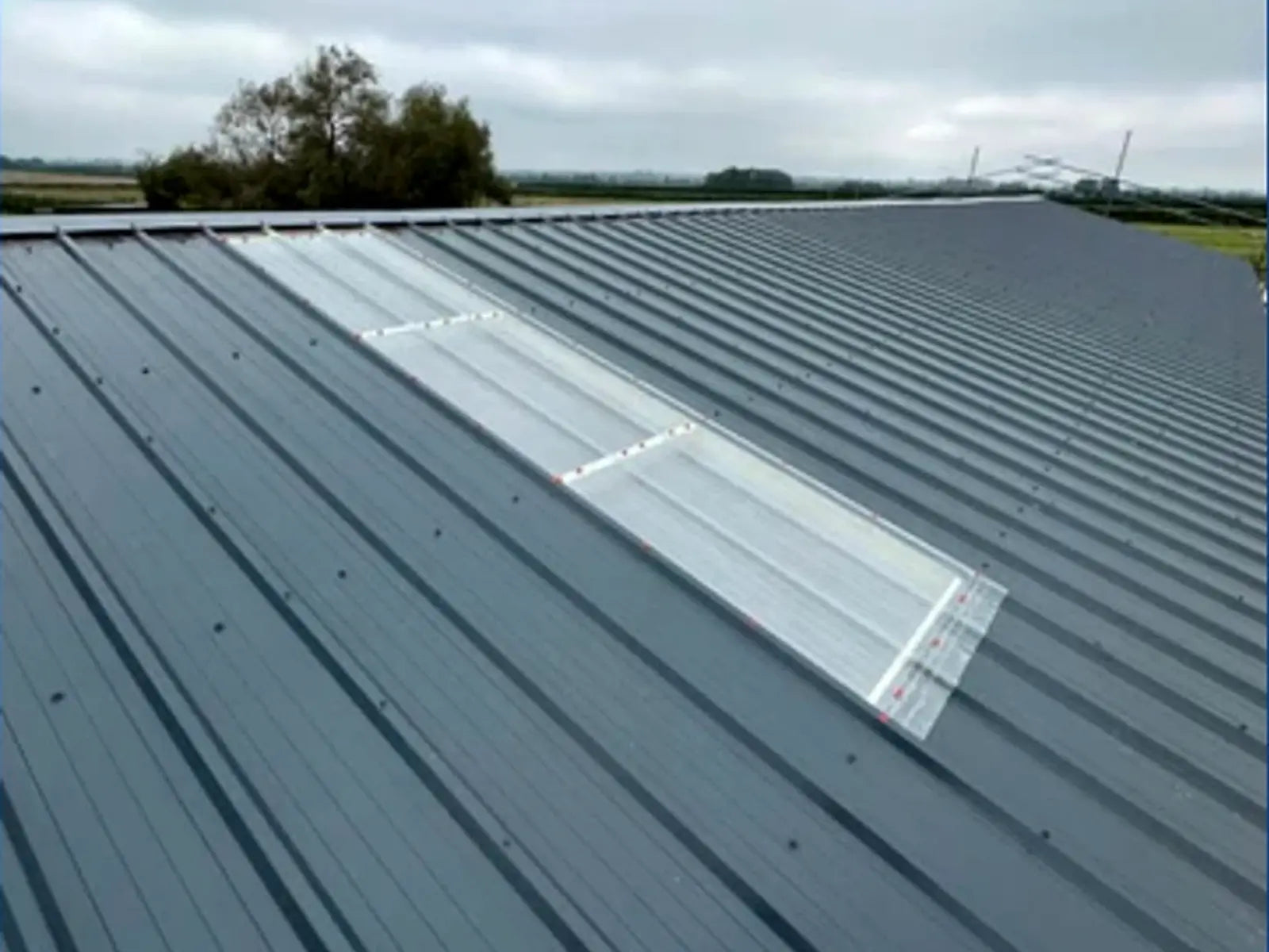 Large metal roof with installed rooflights